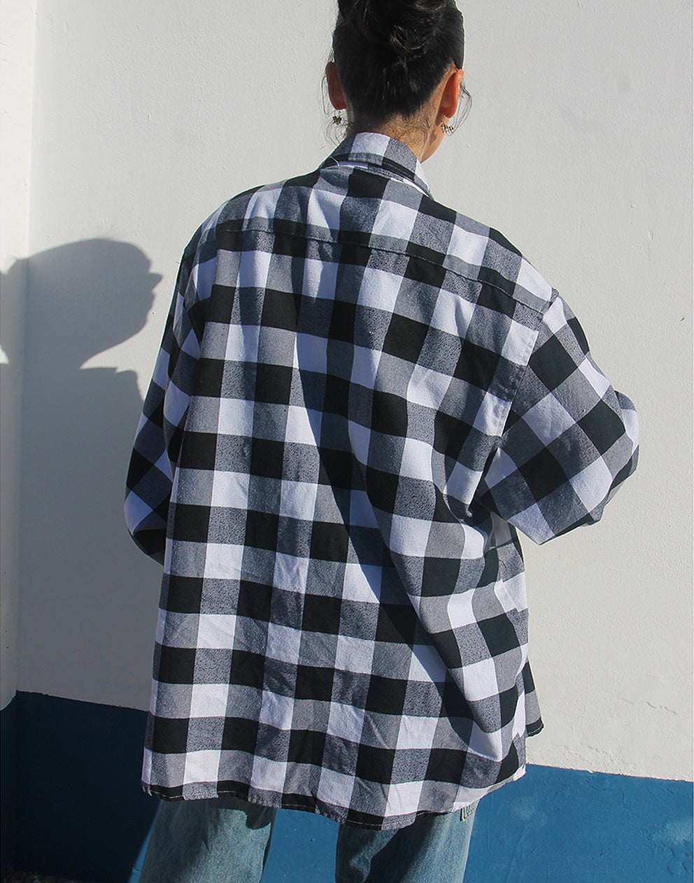 Full-length back view of the long-sleeved flannel shirt showing the relaxed fit and classic check pattern.
