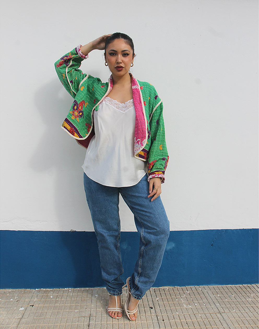 Person wearing a green cotton jacket with a white background