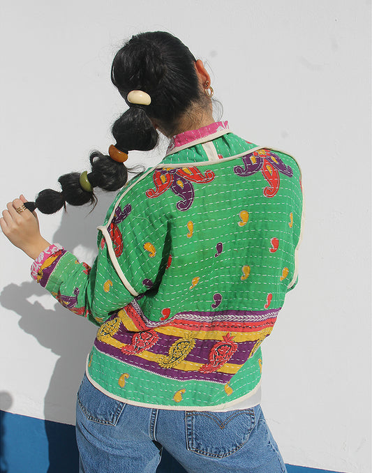 Person wearing a green cotton jacket with a white background