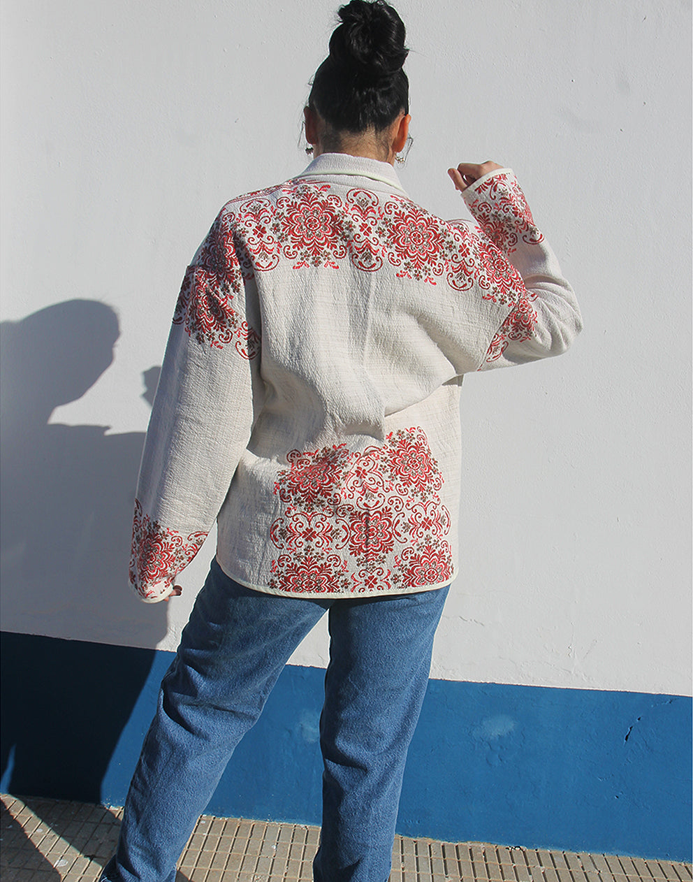 Full-length back view of the unlined cream floral coat showing the lightweight drape.