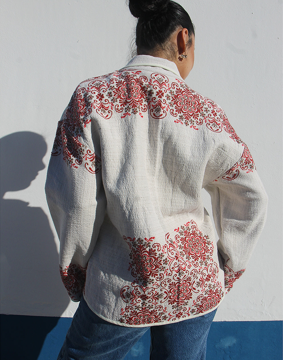 Full-length back view of the unlined cream floral coat showing the lightweight drape.