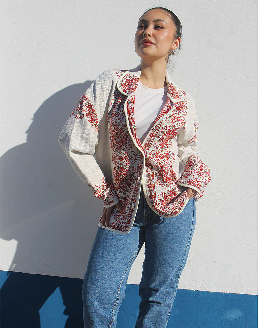 Model wearing the floral statement jacket as a lightweight layer for a casual spring outfit.