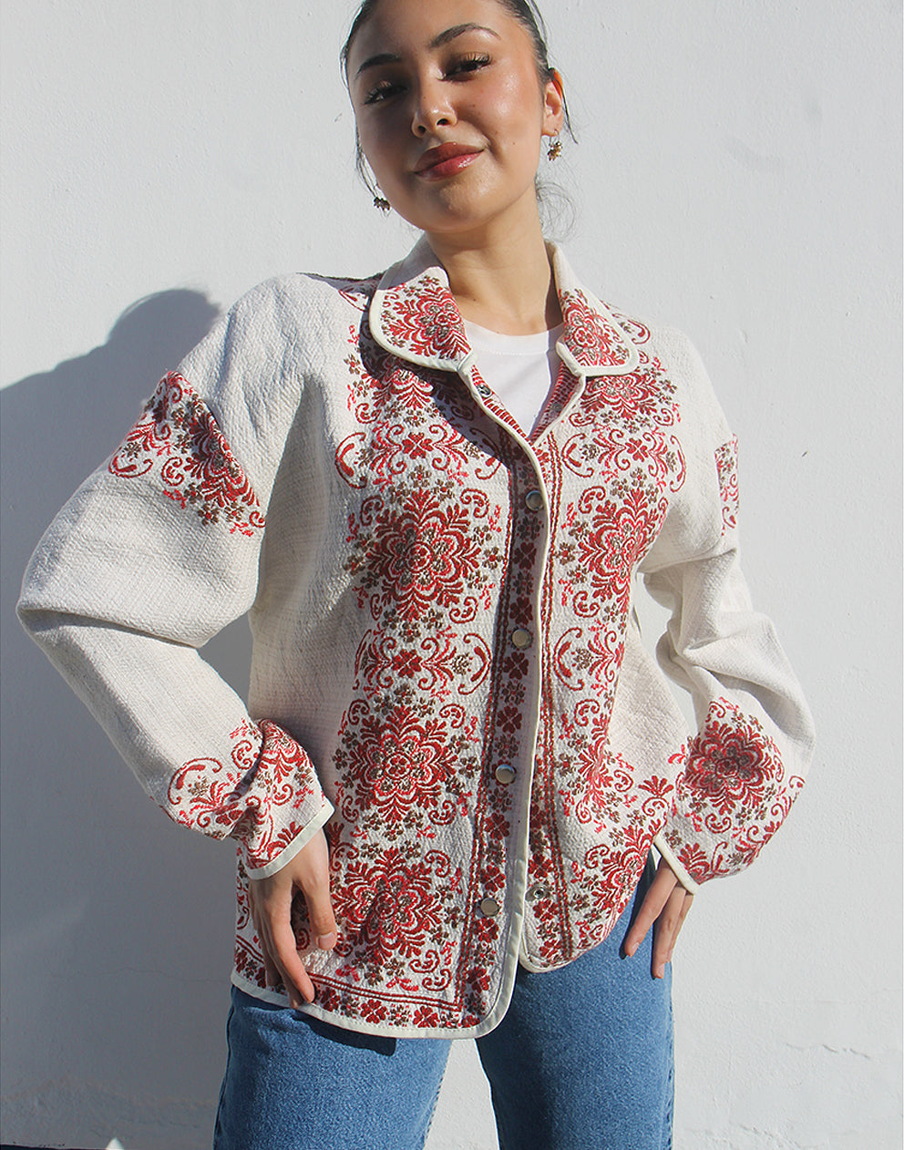 Model wearing the floral statement jacket as a lightweight layer for a casual spring outfit.